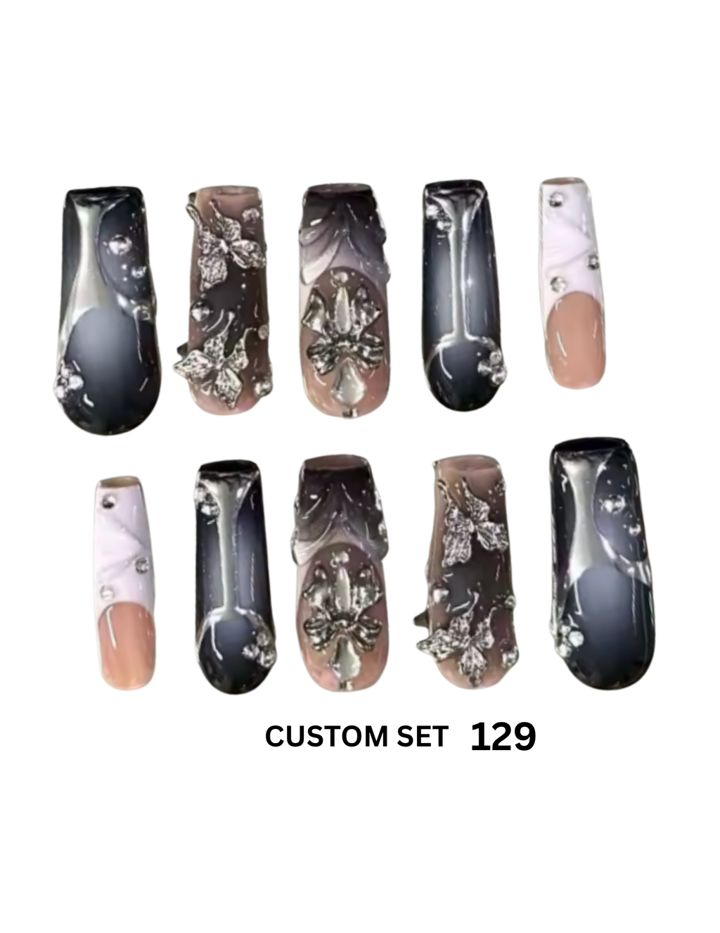 The nails feature marbled black, gray, and beige designs, silver rhinestone embellishments, and nude pink tips.
