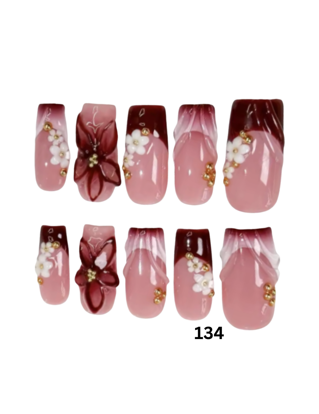 Ten press-on nails featuring a glossy pink and dark burgundy ombre design with white floral details and small gold accents. 