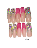 10 press-on nails featuring a mix of solid nude pink nails, bright pink textured accent nails, and glittery rhinestone-embellished nails.