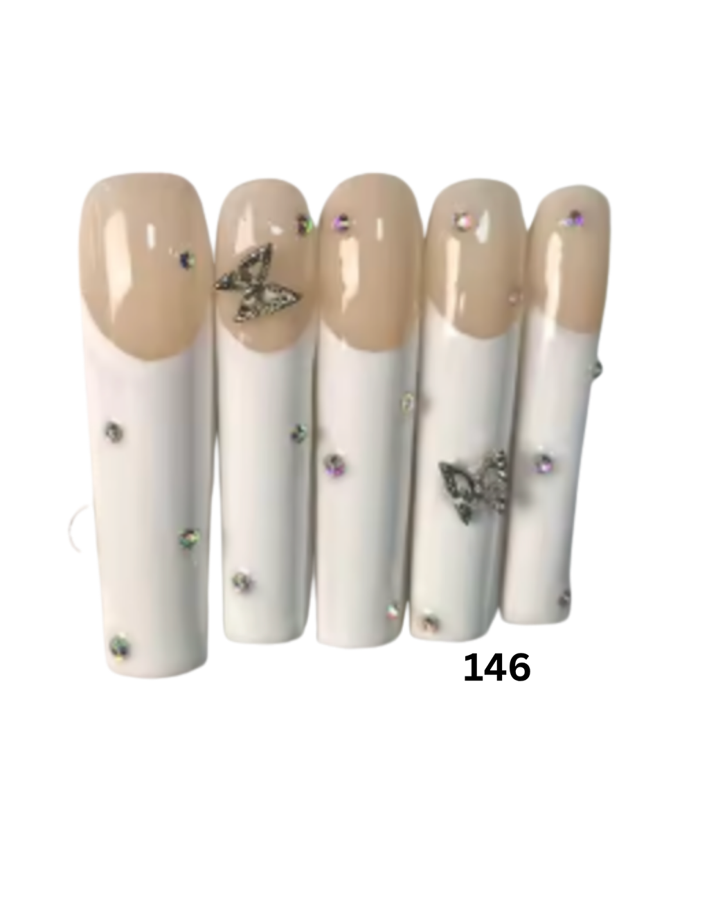 Press-on nails with a glossy nude-beige French tip and a white lower portion, decorated with rhinestones and butterfly embellishments