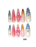 Decorative press-on nails.  The nails feature pastel gradient designs, pink floral motifs, orange-and-white speckled patterns, blue-and-white striped tips, and small gold star embellishments.