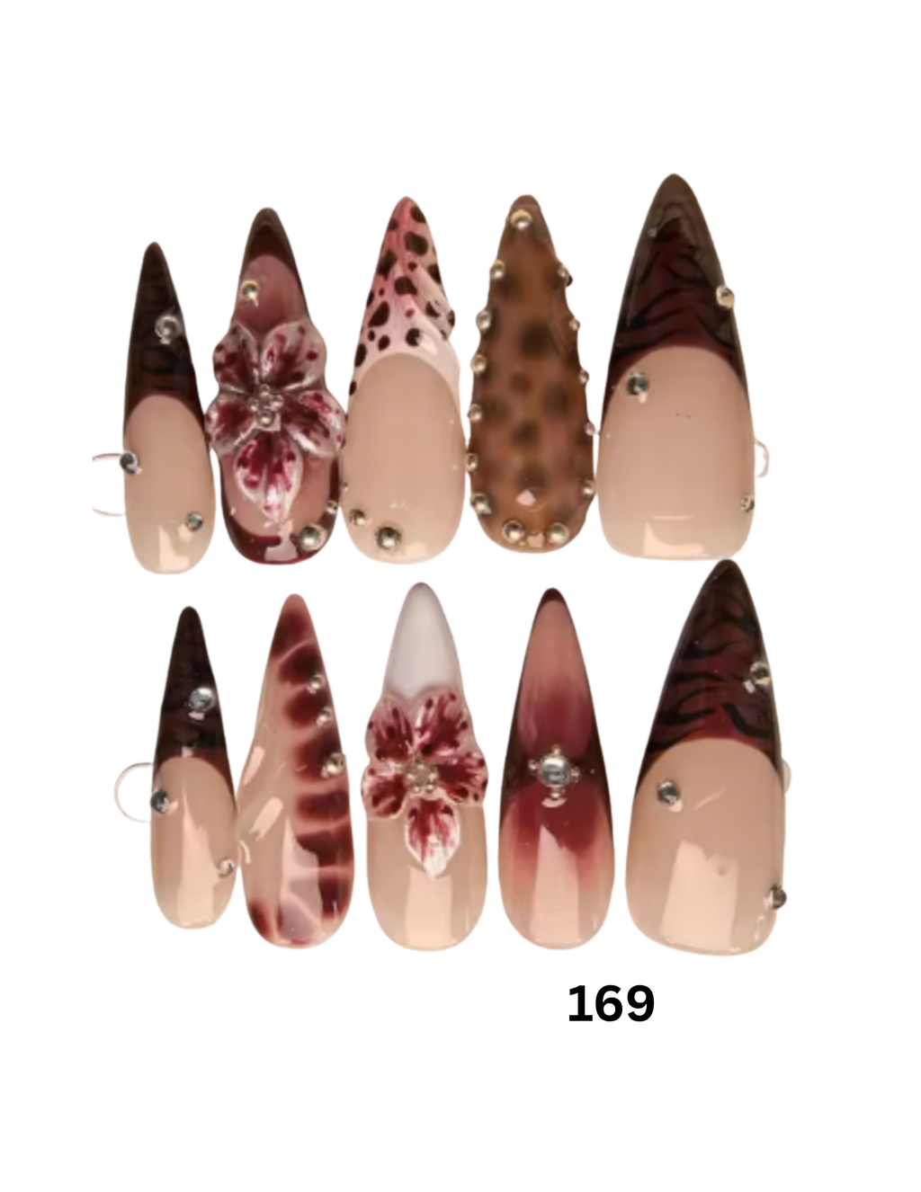 Long stiletto-shaped press-on nails featuring various designs in shades of brown, burgundy, beige, and floral embellishments