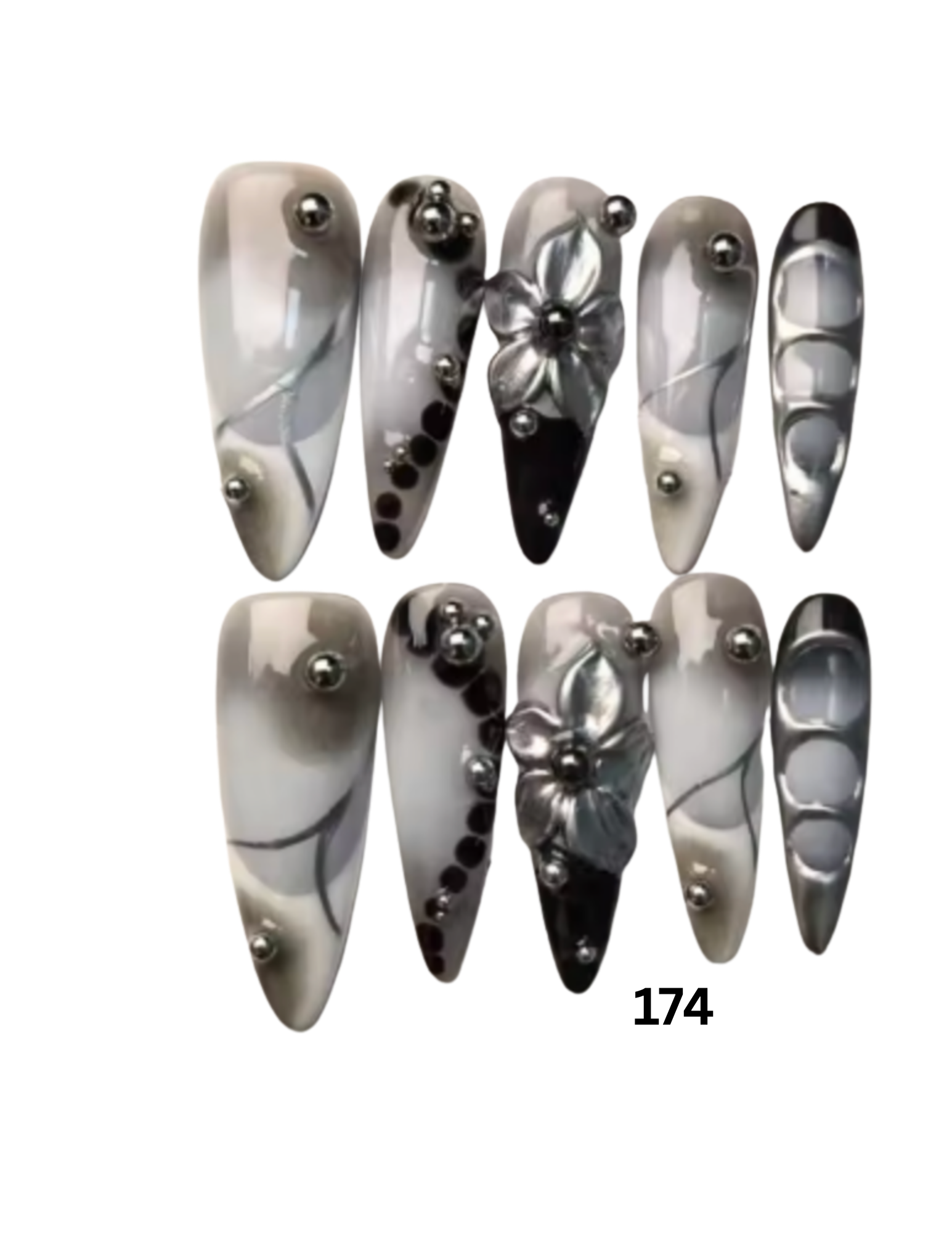 A set of 10 stiletto-shaped press-on nails. The nails feature a glossy black, white, and gray marbled pattern with silver metallic bead accents and two silver 3D floral designs.
