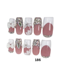 Set of 10 press-on nails with a pink and white French manicure design, embellished with rhinestones and white flower details, 