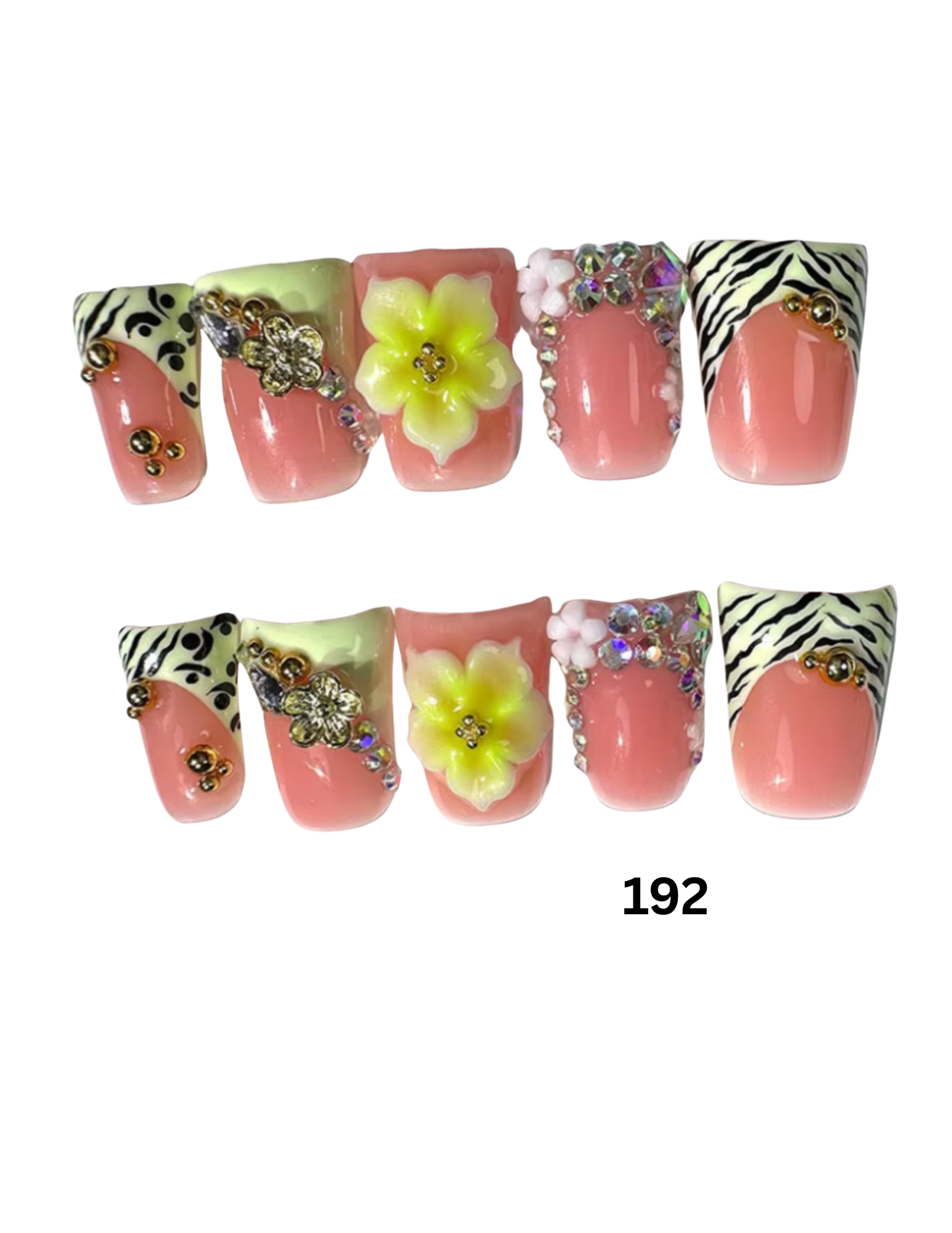Two rows of decorative press-on nails. The nails are glossy pink with black-and-white zebra striping, pale yellow flower accents, rhinestone embellishments, and small gold dot details.